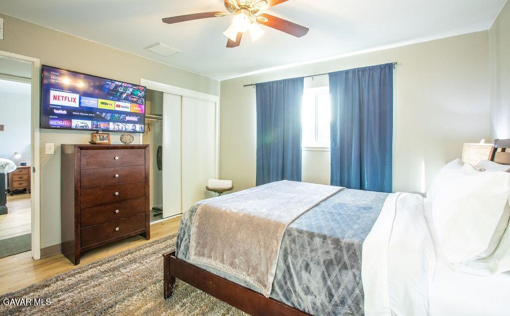 349 South Margalo Street Ridgecrest, CA 93555 - Photo 10 of 14 a bedroom with a bed and a flat tv screen on dresser