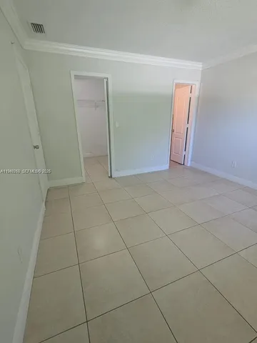 a view of an empty room and a hallway