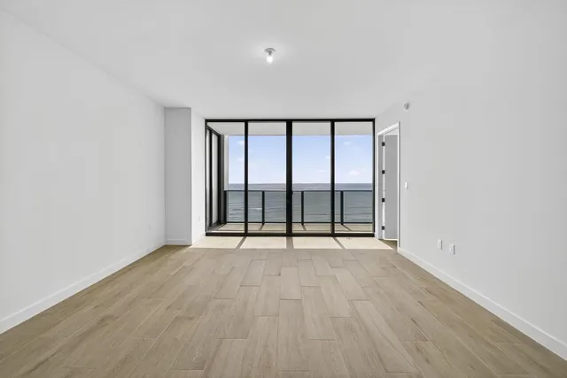 a view of an empty room and wooden floor