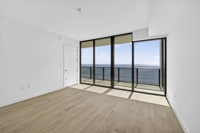 a bathroom with a shower sink vanity mirror and toilet