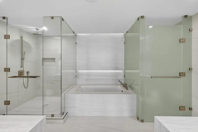 a bathroom with a granite countertop sink a toilet and shower