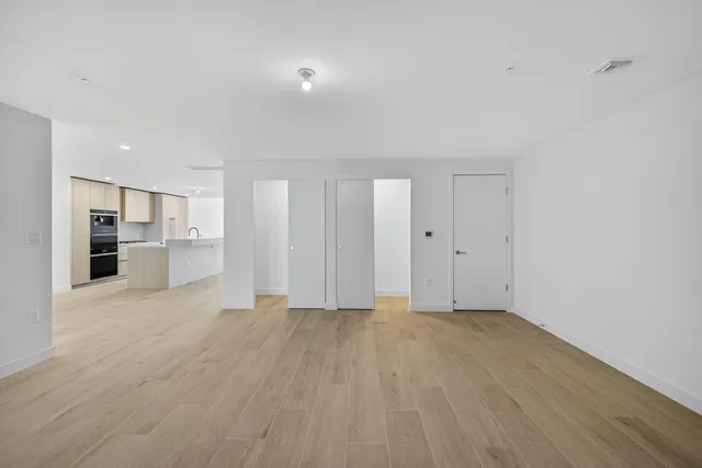 a living room with furniture a large window and a chandelier