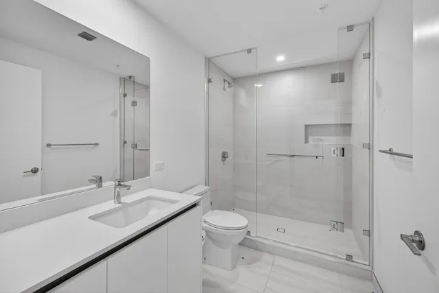 a row of palm trees in a backyard of a house