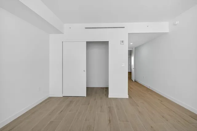 a view of swimming pool with outdoor seating and palm trees