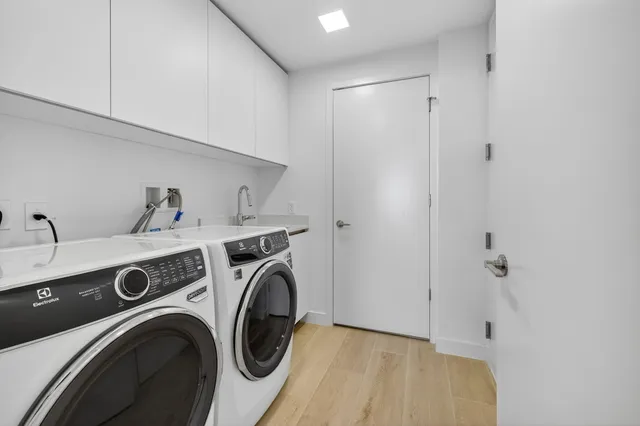 a front view of a building with a garden and plants