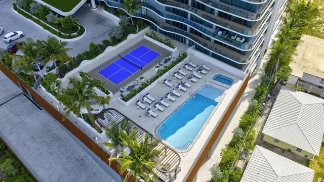 a large white kitchen with a sink and refrigerator