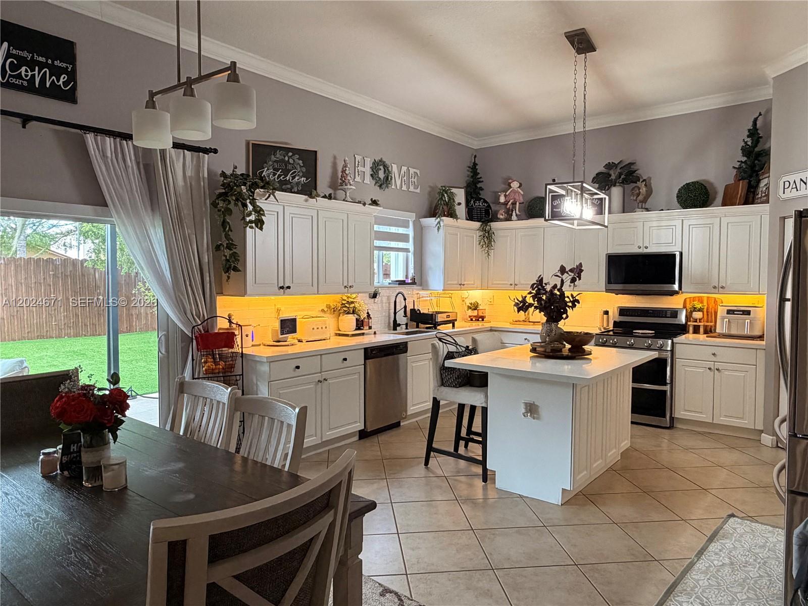 2116 Northeast 38th Road, Unit 2116 Homestead, FL 33033 - Photo 26 of 31 a kitchen with a sink appliances and cabinets