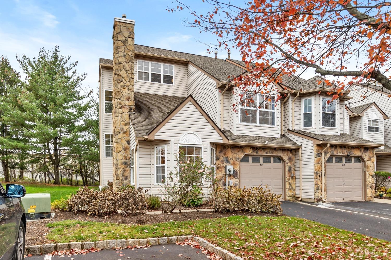 a view of a white house with large windows and a small yard