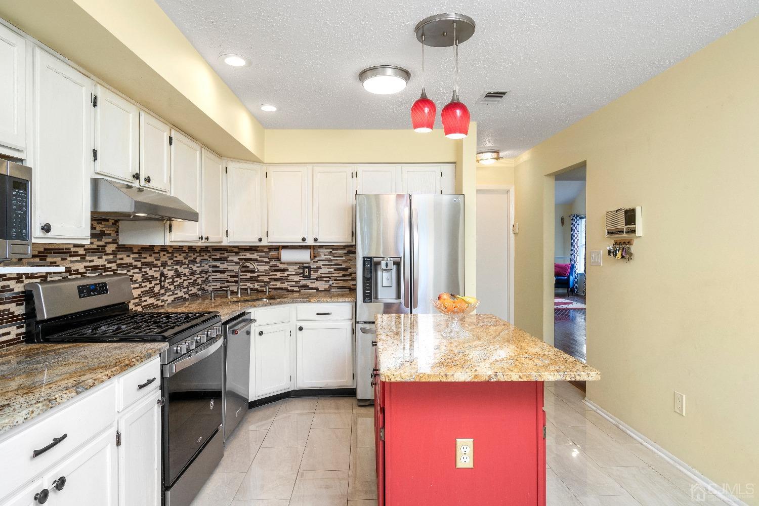 231 Nebula Road Piscataway, NJ 08854 - Photo 11 of 37 a kitchen with stainless steel appliances granite countertop a sink stove and refrigerator