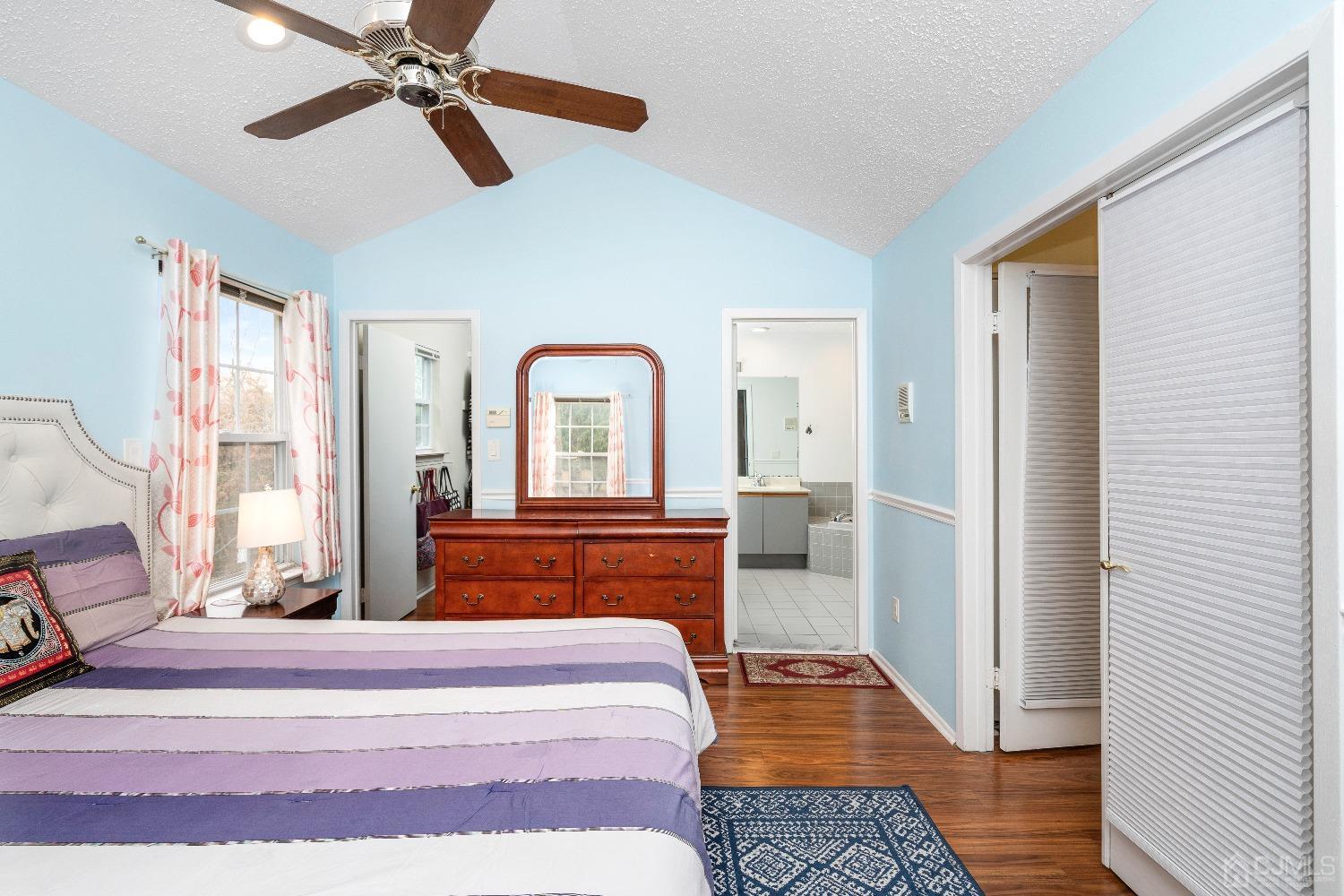 231 Nebula Road Piscataway, NJ 08854 - Photo 17 of 37 a bedroom with a bed and a chandelier