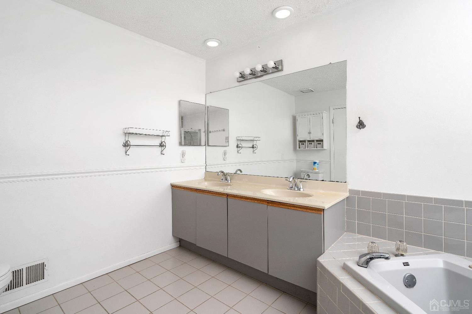 231 Nebula Road Piscataway, NJ 08854 - Photo 18 of 37 a bathroom with a sink and mirror
