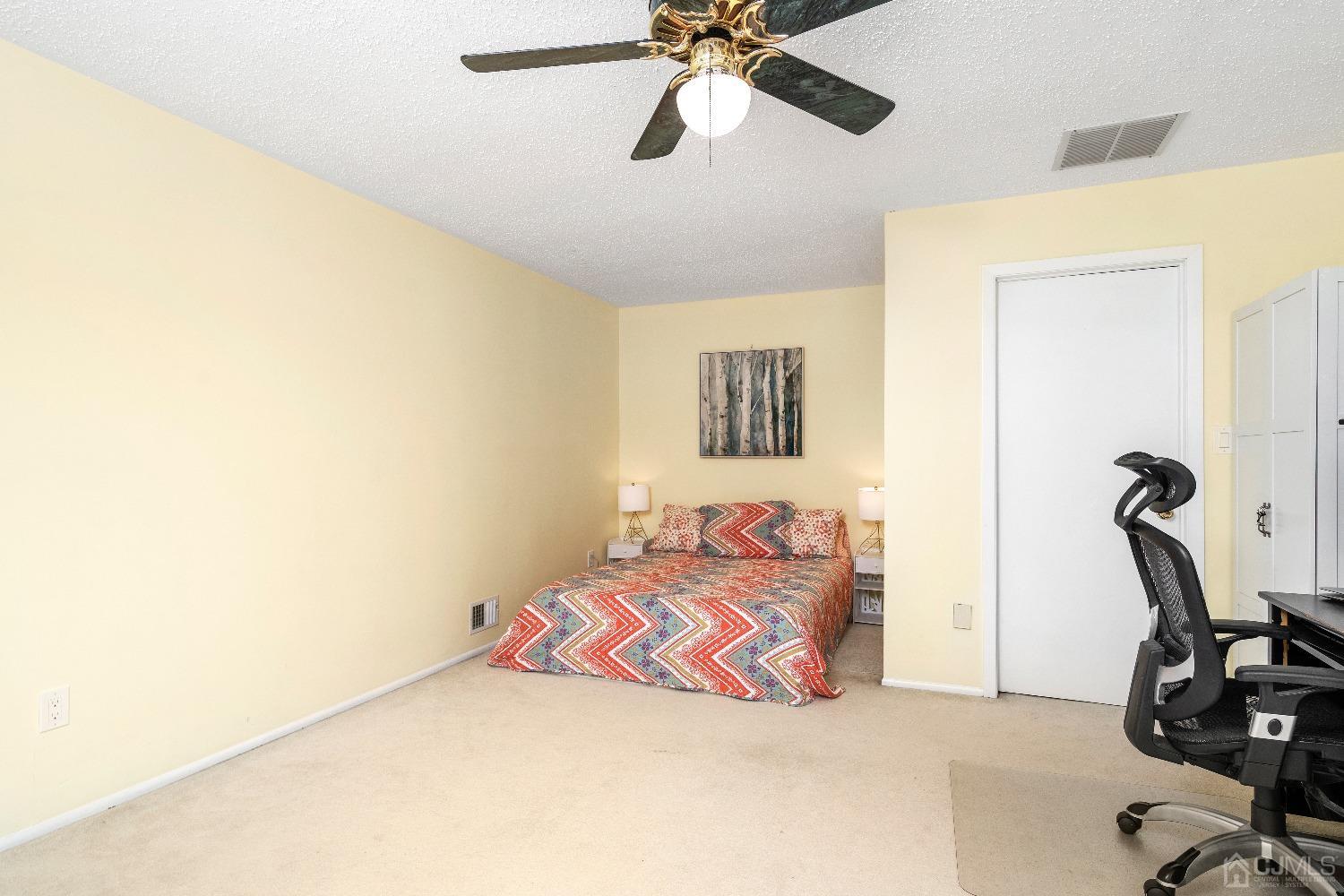 231 Nebula Road Piscataway, NJ 08854 - Photo 24 of 37 a bedroom with a bed and a chandelier