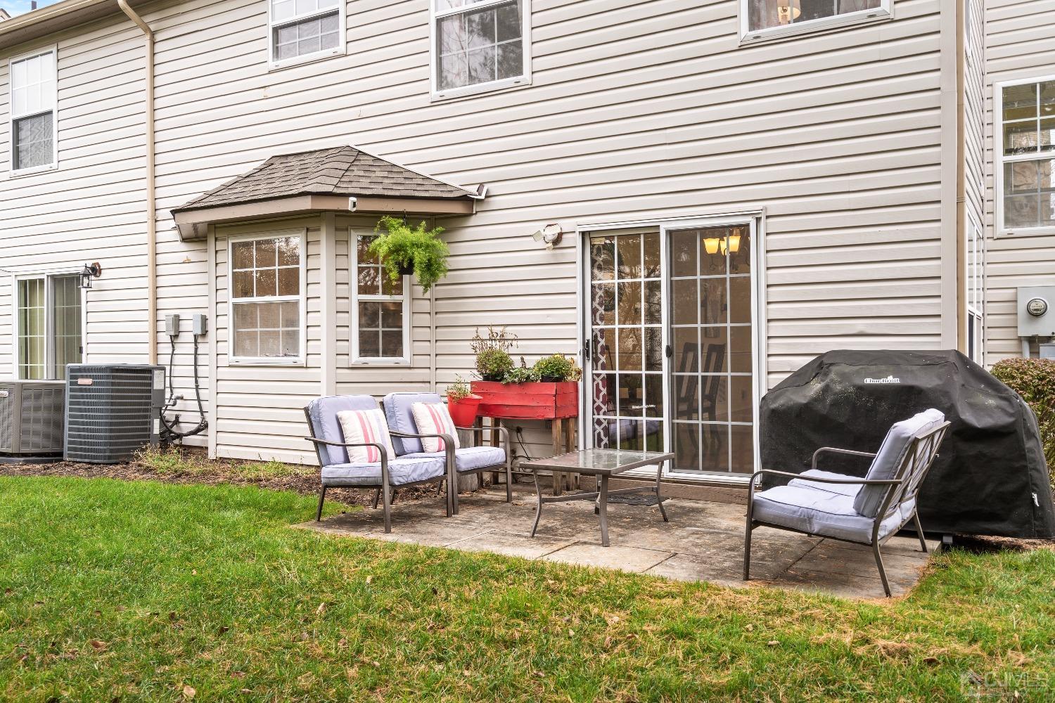231 Nebula Road Piscataway, NJ 08854 - Photo 27 of 37 a chair and table sitting in front of a house
