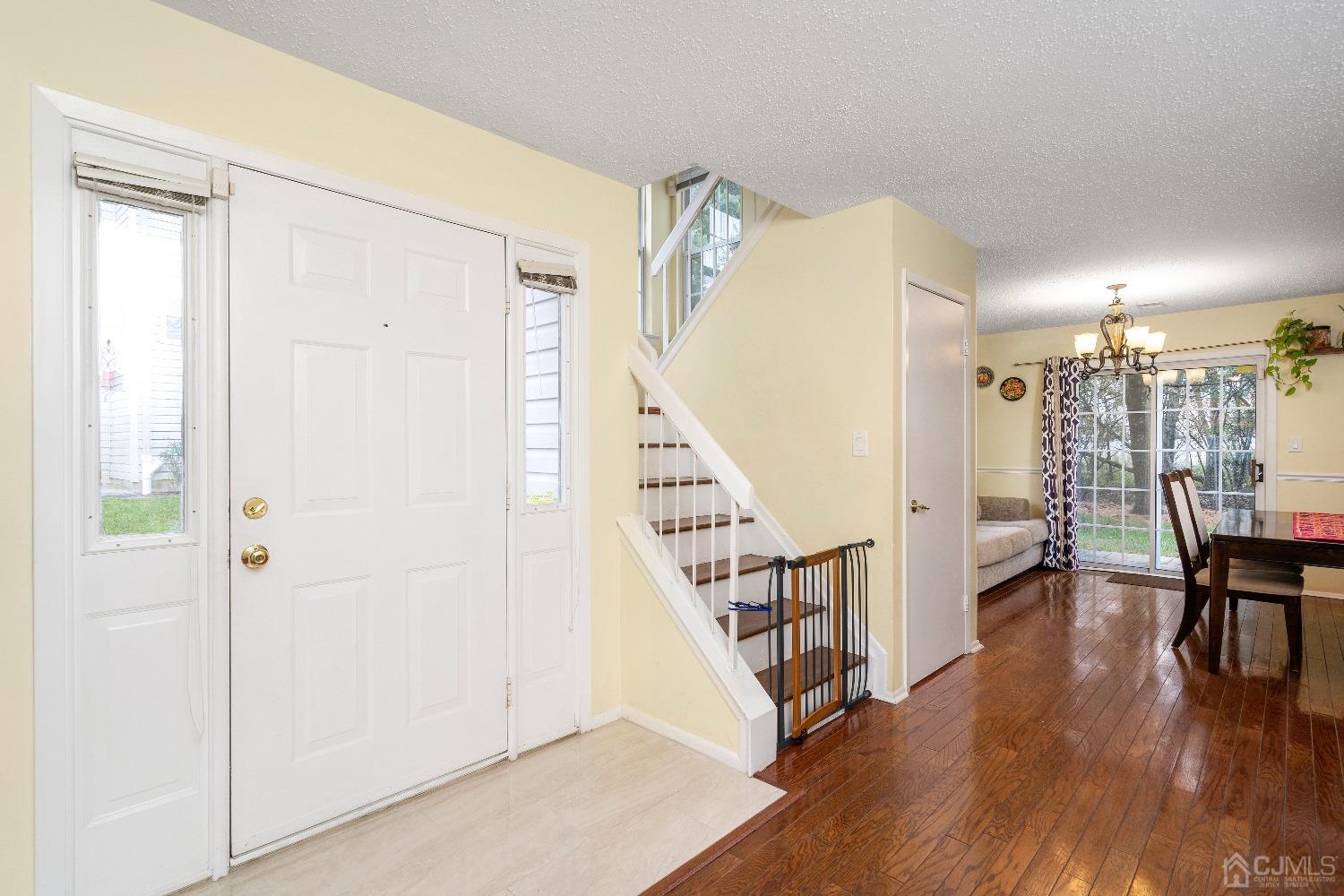 231 Nebula Road Piscataway, NJ 08854 - Photo 6 of 37 a view of a hallway with wooden floor and dining room