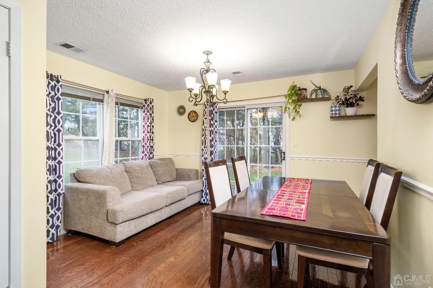 231 Nebula Road Piscataway, NJ 08854 - Photo 7 of 37 a living room with furniture and a chandelier