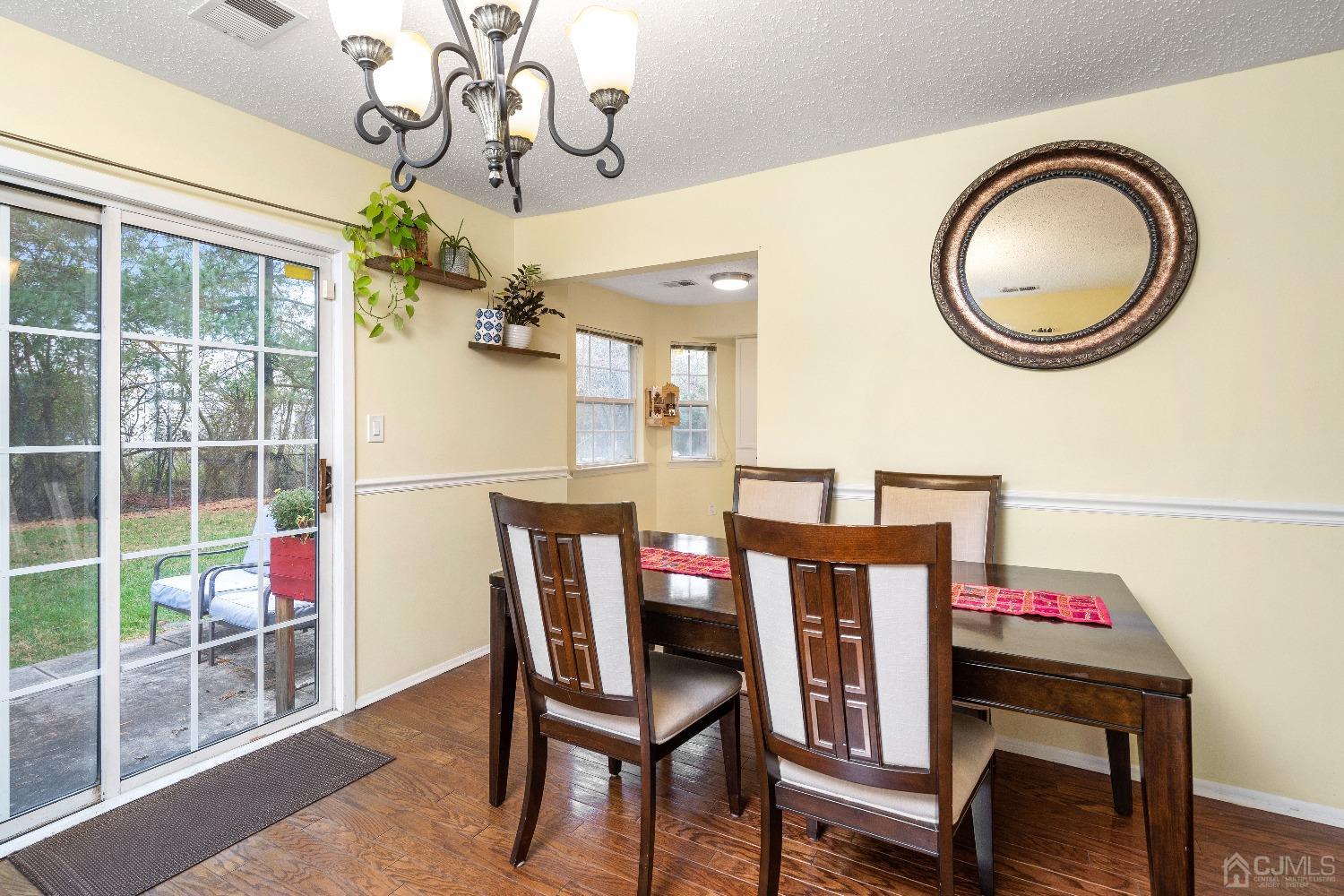 231 Nebula Road Piscataway, NJ 08854 - Photo 8 of 37 a view of a dining room with furniture and a chandelier