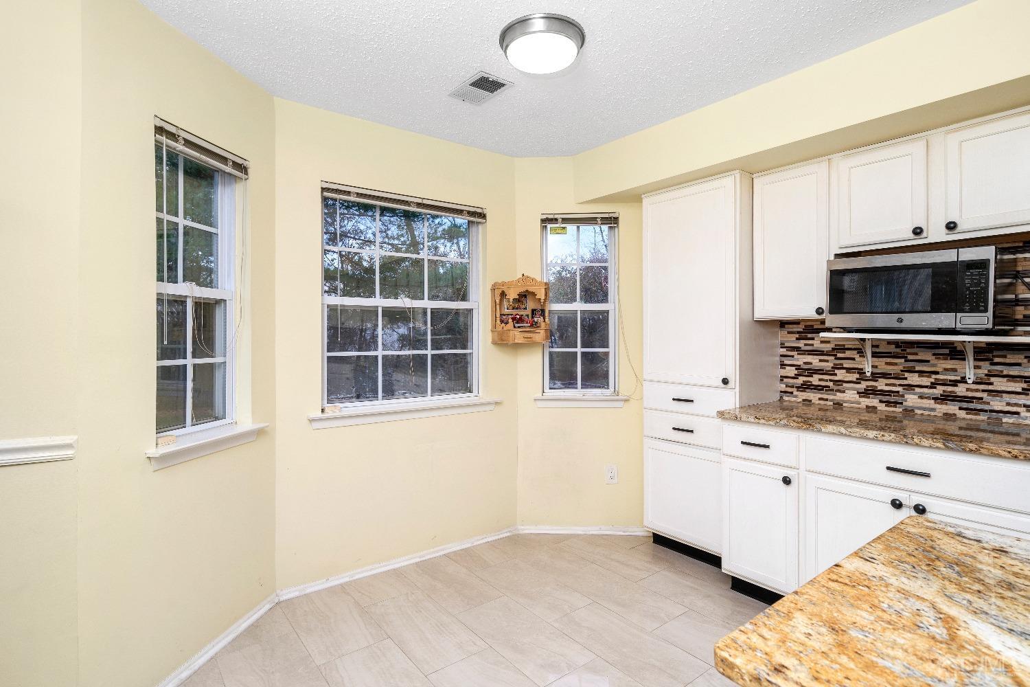 231 Nebula Road Piscataway, NJ 08854 - Photo 9 of 37 a kitchen with stainless steel appliances a stove a sink and a microwave