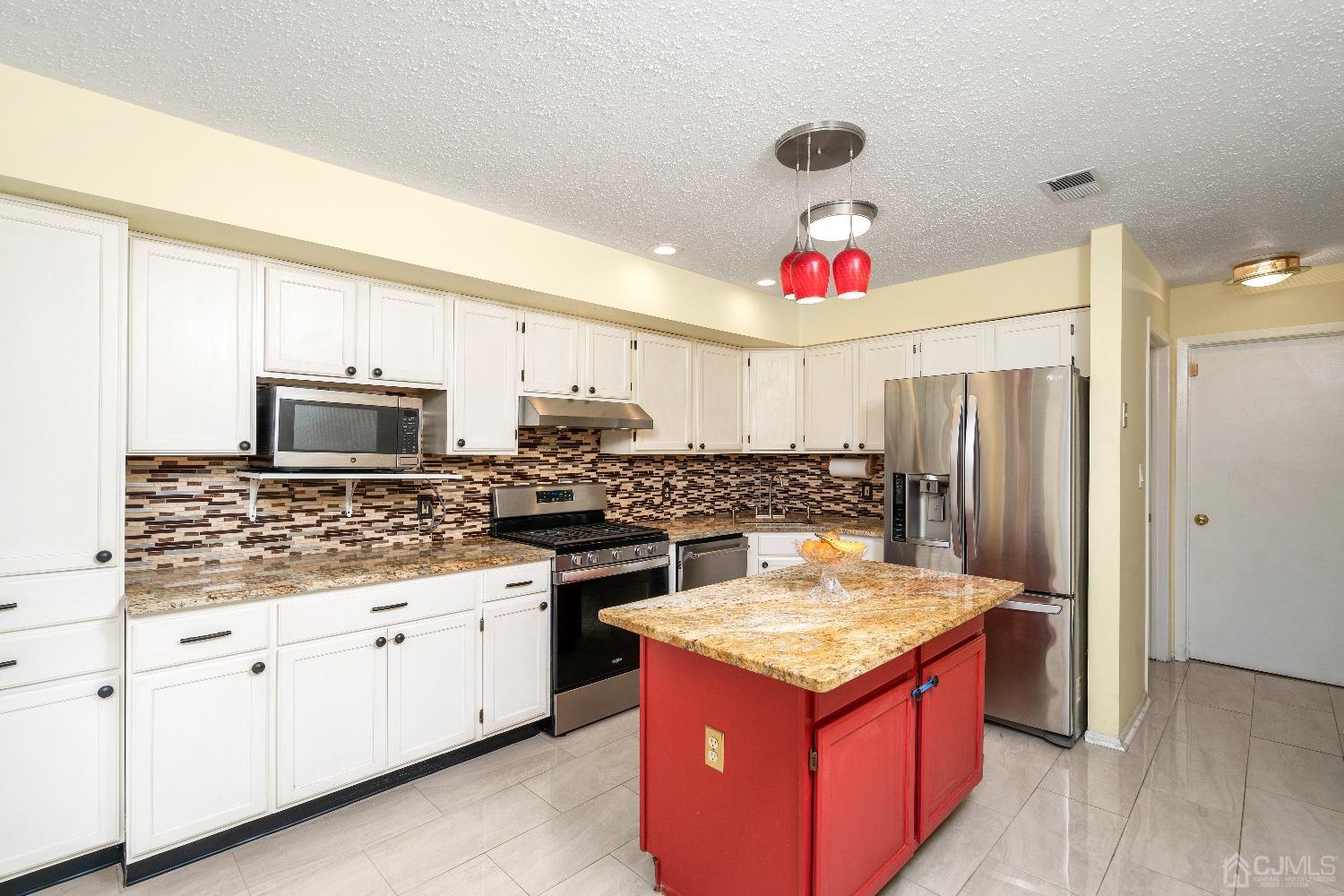 231 Nebula Road Piscataway, NJ 08854 - Photo 10 of 37 a kitchen with a stove cabinets and utility