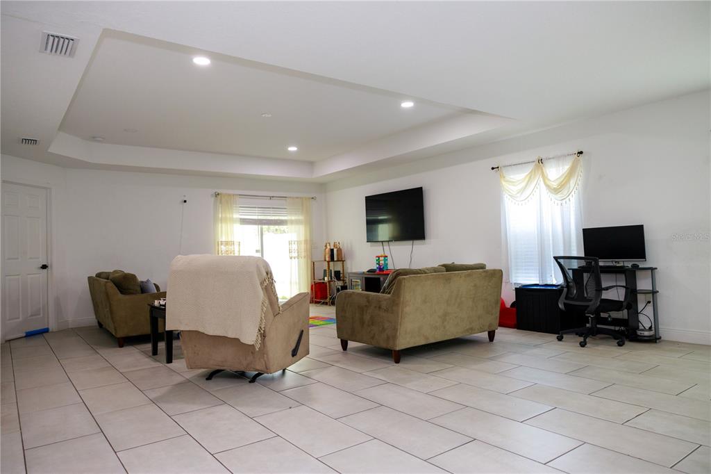 5112 Pacific Spring Hill, FL 34606 - Photo 12 of 13 a living room with furniture and a flat screen tv