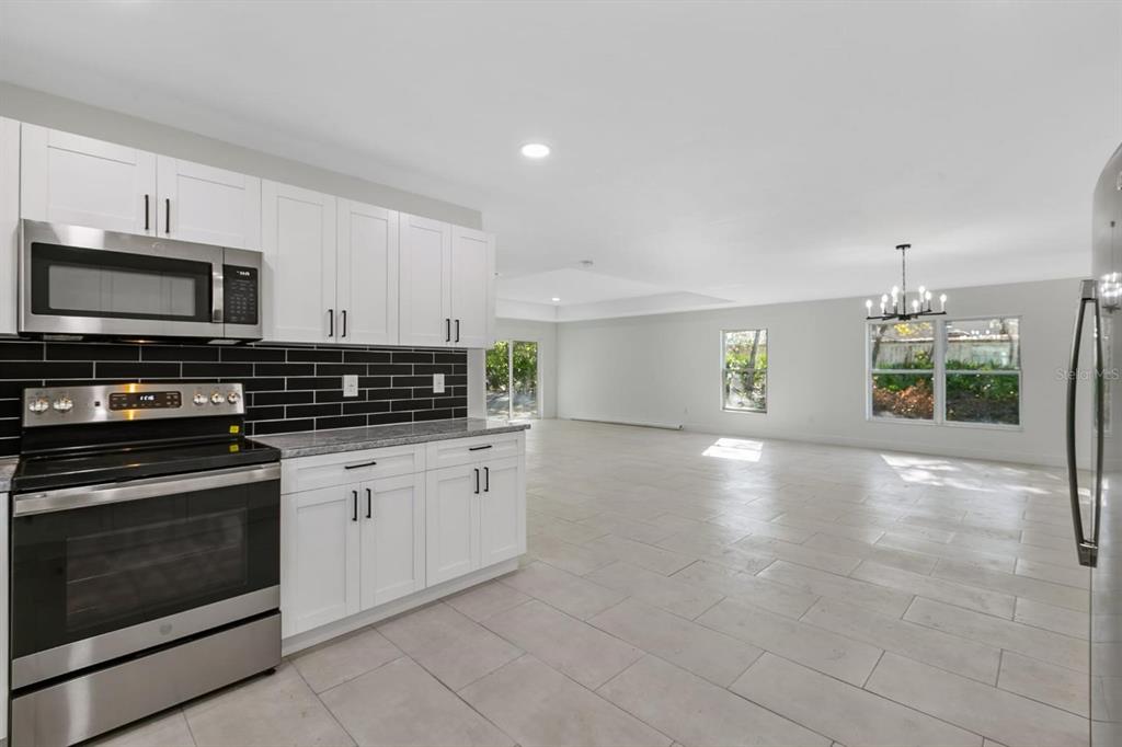 5112 Pacific Spring Hill, FL 34606 - Photo 2 of 13 a kitchen with stainless steel appliances a stove sink and microwave