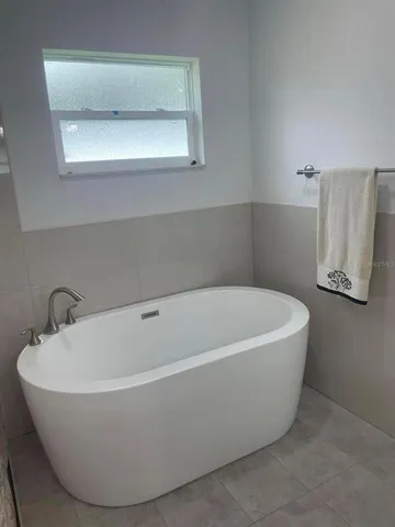 a white bath tub sitting in a bathroom
