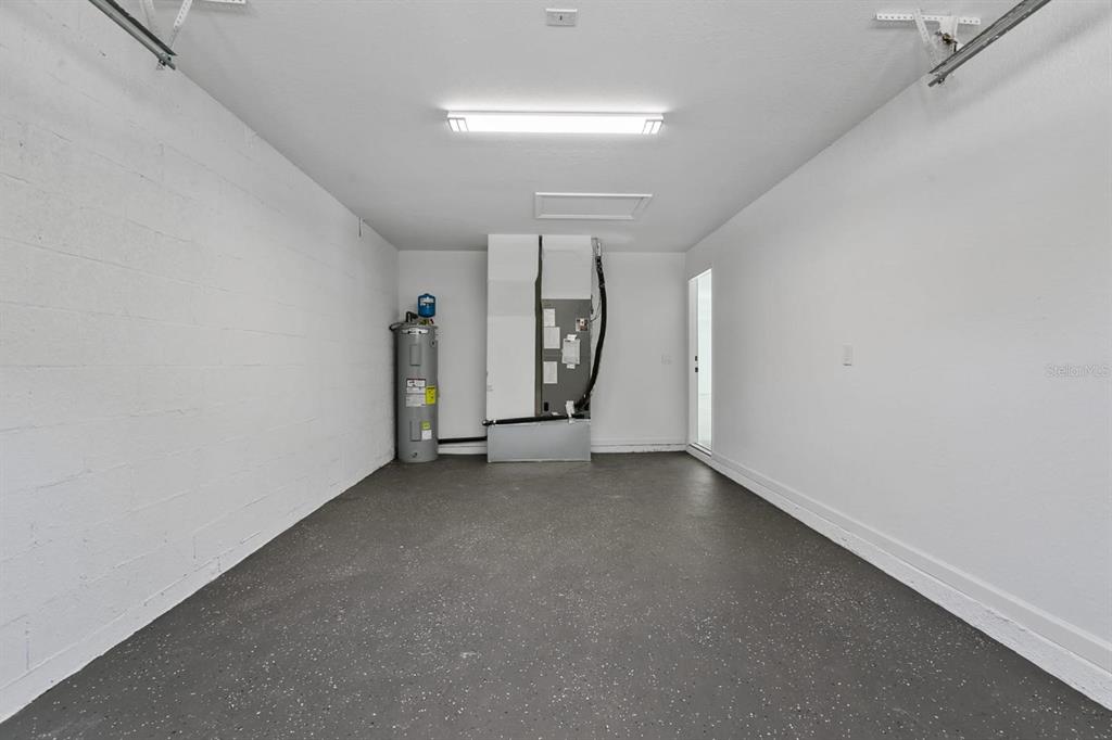 5112 Pacific Spring Hill, FL 34606 - Photo 9 of 13 an empty room with chandelier fan and windows