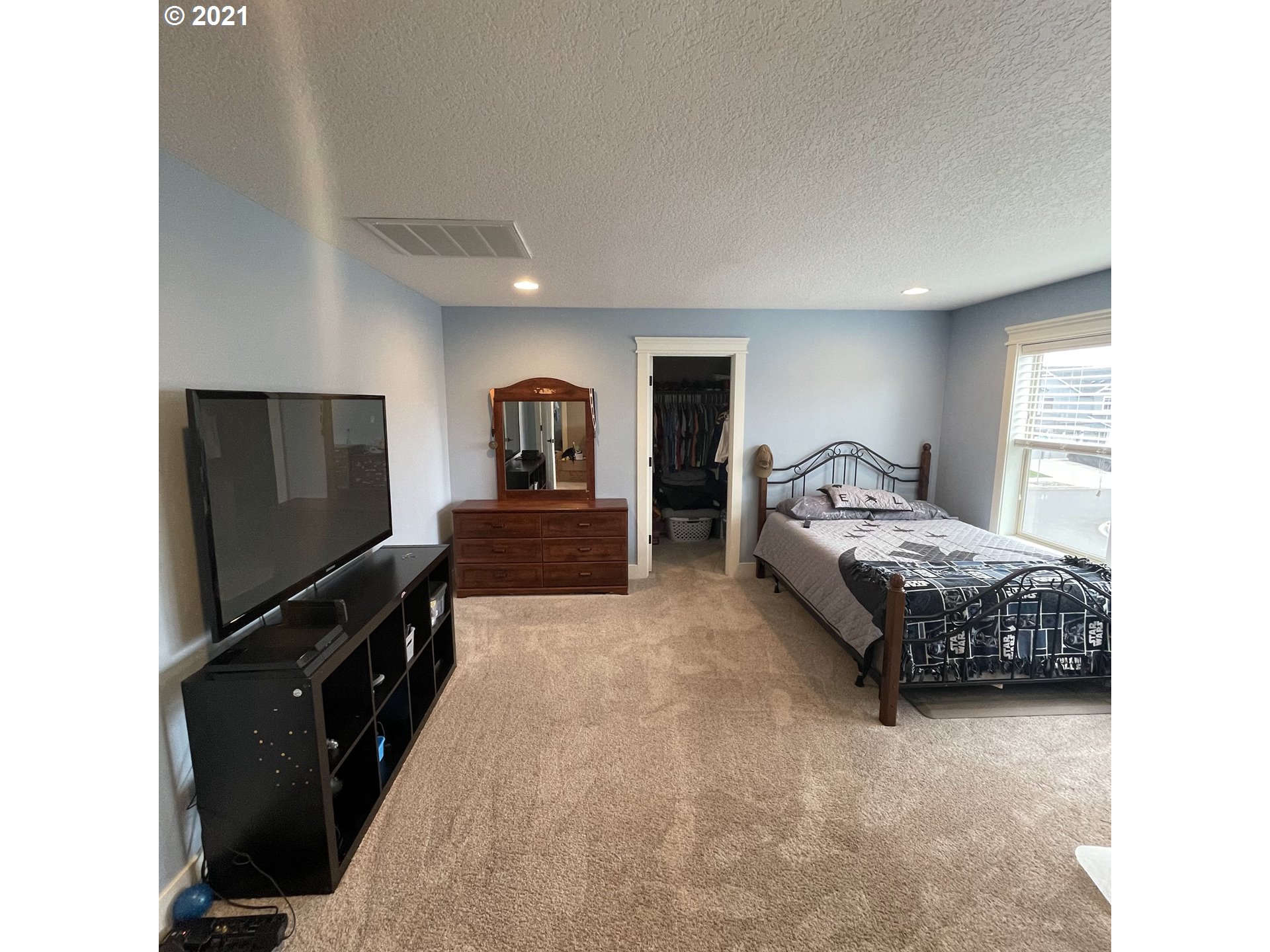 4552 North 9th Street Ridgefield, WA 98642 - Photo 13 of 29 a bedroom with a bed and a flat screen tv