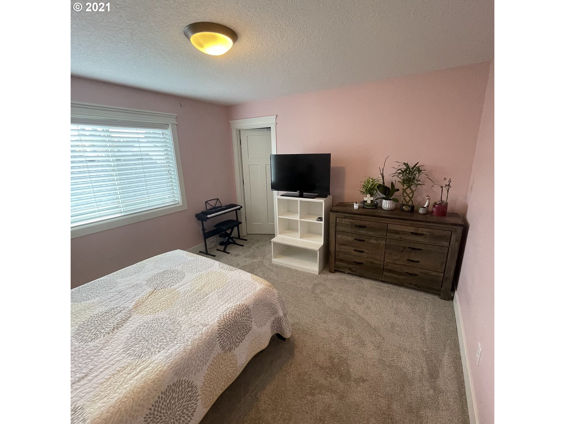 4552 North 9th Street Ridgefield, WA 98642 - Photo 17 of 29 a bedroom with a bed and a flat screen tv
