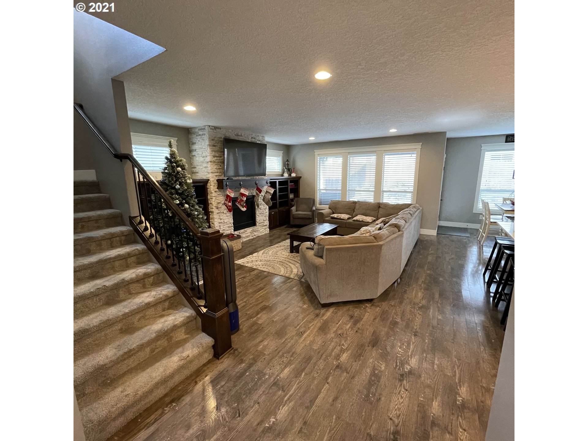 4552 North 9th Street Ridgefield, WA 98642 - Photo 3 of 29 a living room with couches and kitchen view with wooden floor
