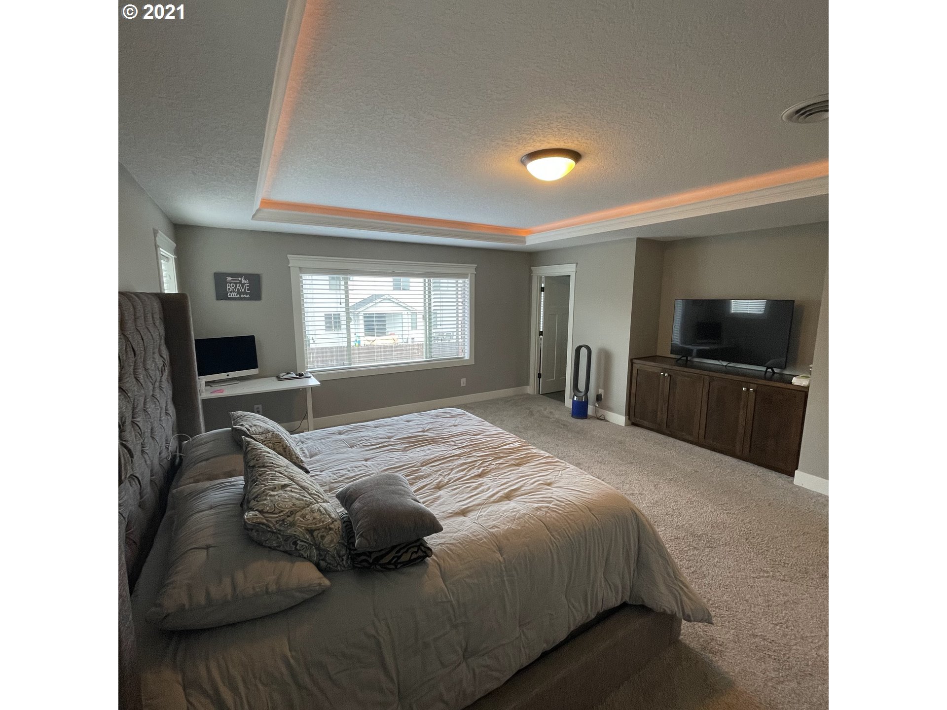 4552 North 9th Street Ridgefield, WA 98642 - Photo 22 of 29 a bedroom with a large bed and a flat screen tv