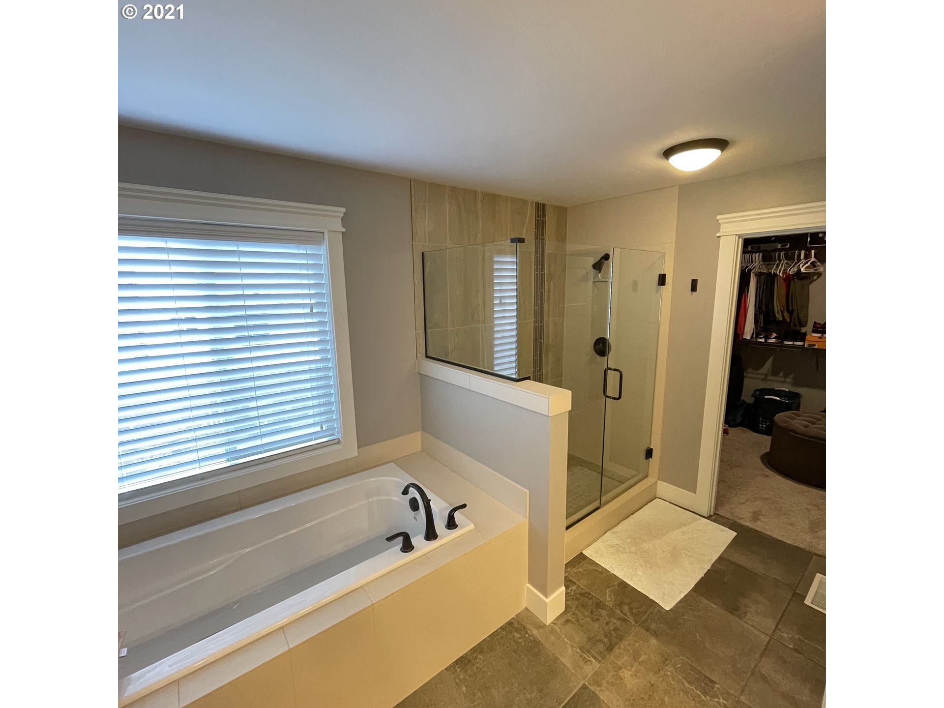 4552 North 9th Street Ridgefield, WA 98642 - Photo 24 of 29 a bathroom with a tub sink shower and a mirror