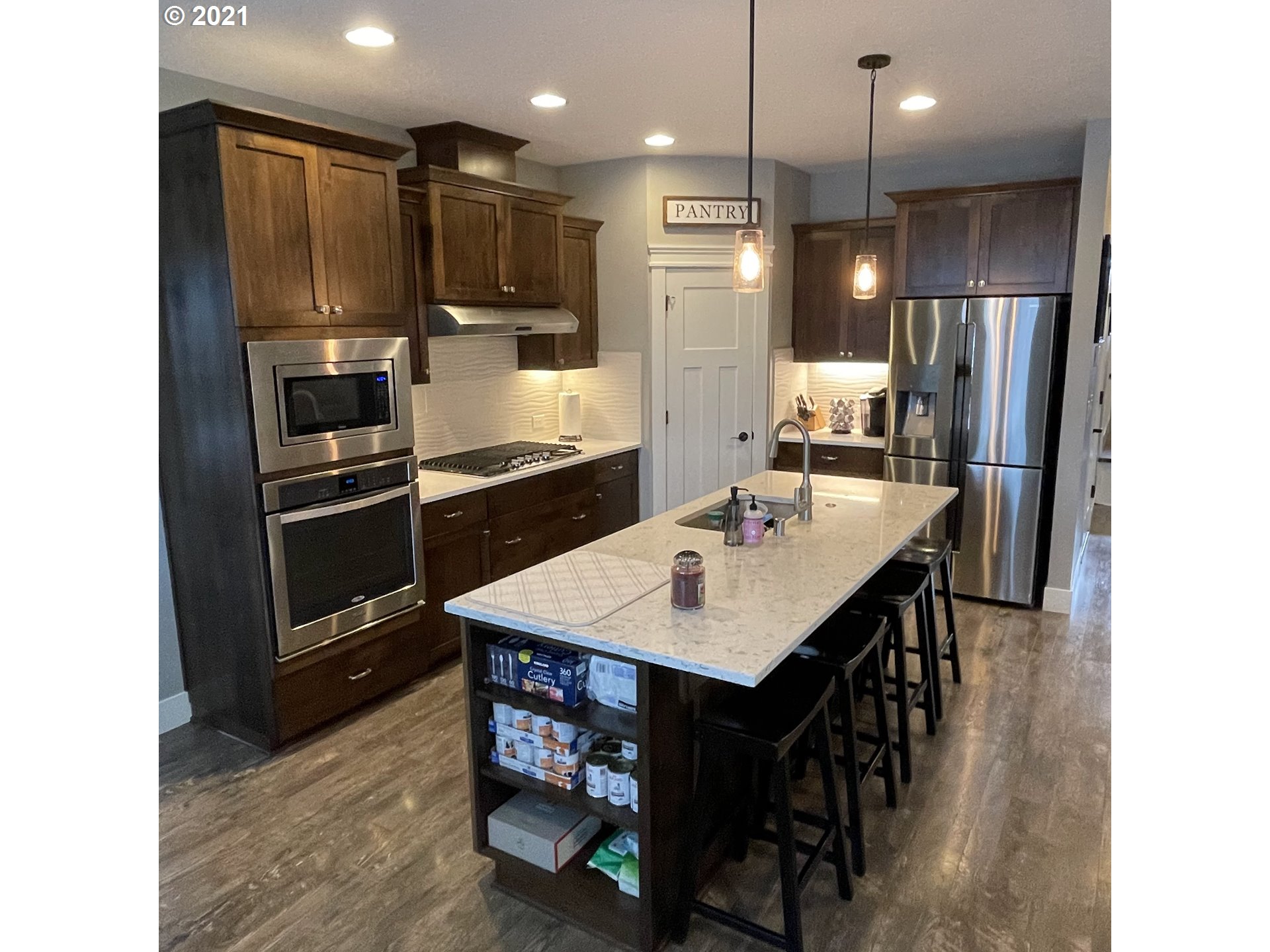 4552 North 9th Street Ridgefield, WA 98642 - Photo 5 of 29 a kitchen with kitchen island a sink stove and refrigerator