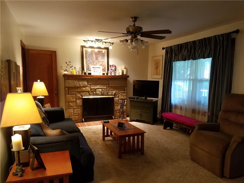 Living Room with wood burning stone fireplace. 