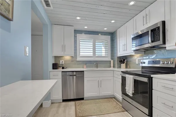 a kitchen with stainless steel appliances granite countertop a sink and stove top oven