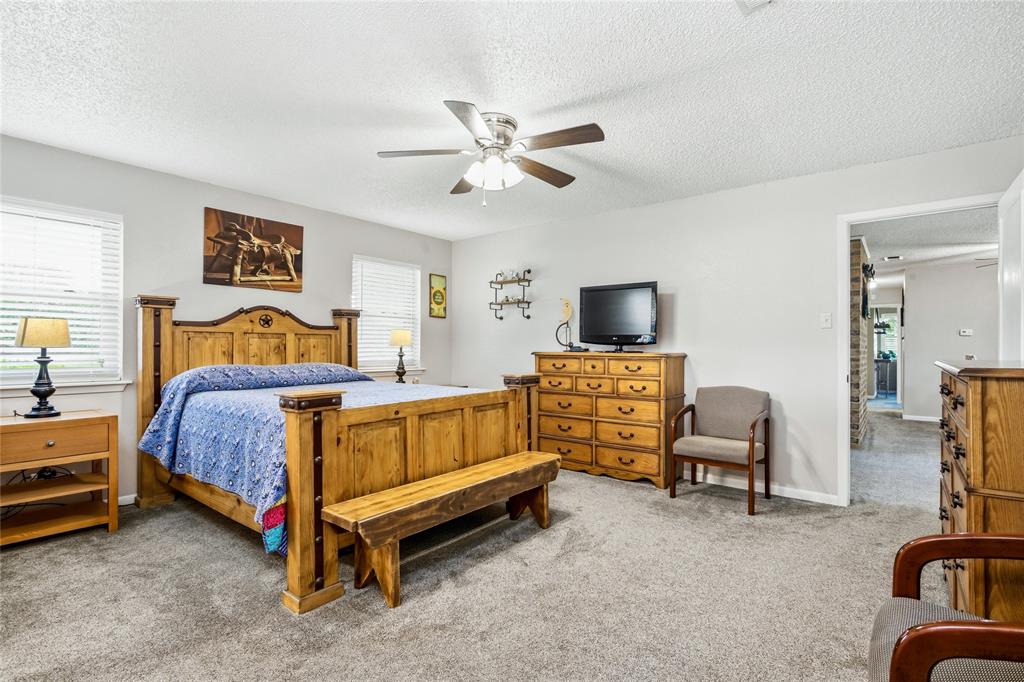 235 Magnus Road Denison, TX 75021 - Photo 18 of 35 a bedroom with bed and a couch