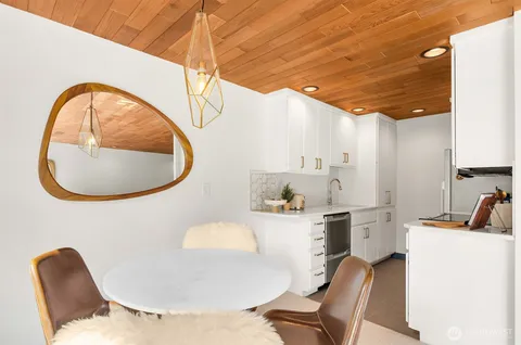 a bathroom with a granite countertop sink a toilet and a mirror