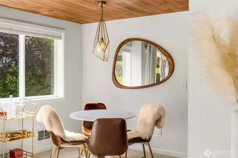 a view of a dining room with furniture and a window