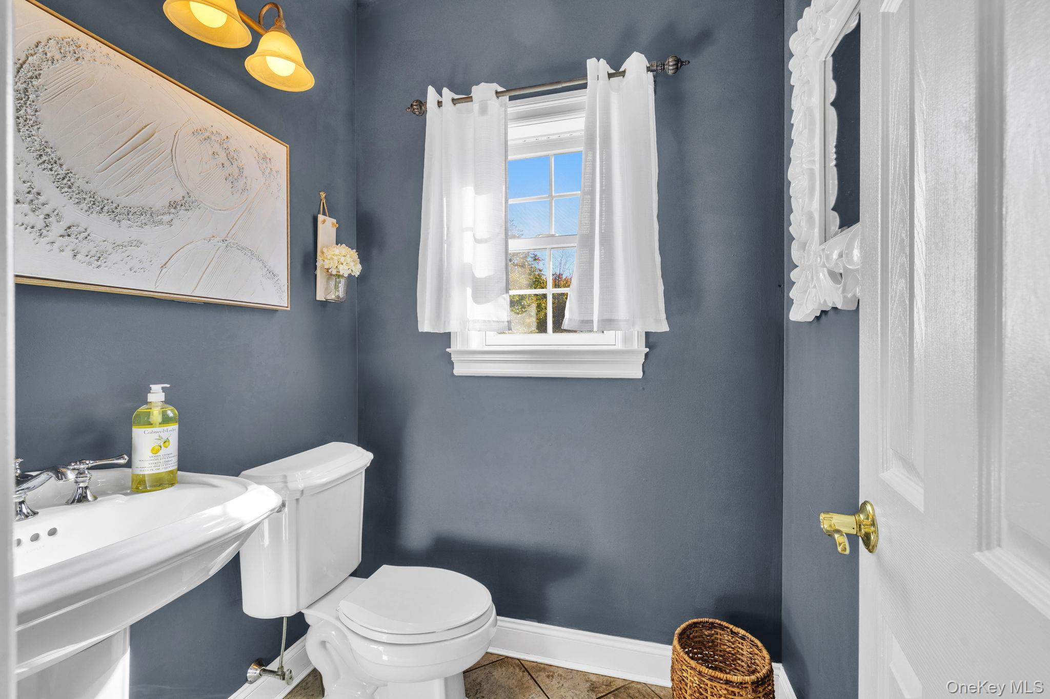 1174 Mountain Road Port Jervis, NY 12771 - Photo 17 of 34 a white toilet sitting next to a bathroom sink and vanity