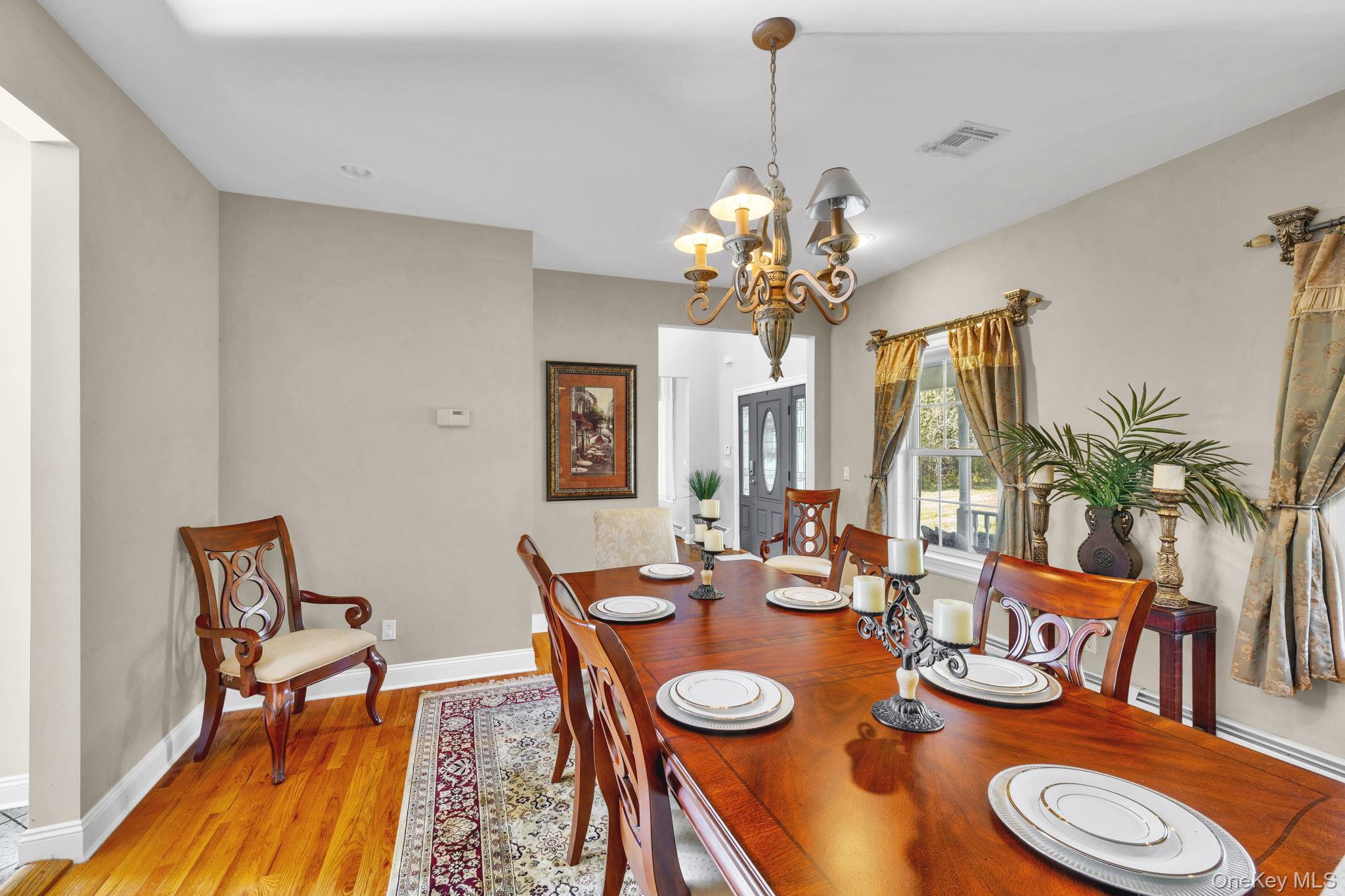 1174 Mountain Road Port Jervis, NY 12771 - Photo 19 of 34 a view of a dining room with furniture a chandelier and wooden floor