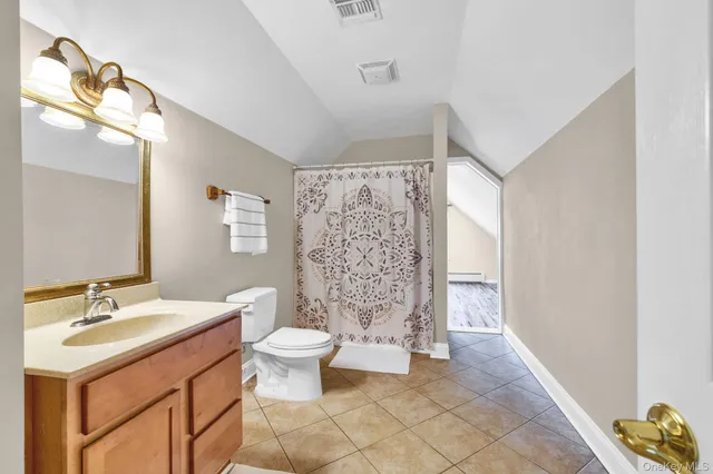 a bathroom with a sink toilet a mirror and shower