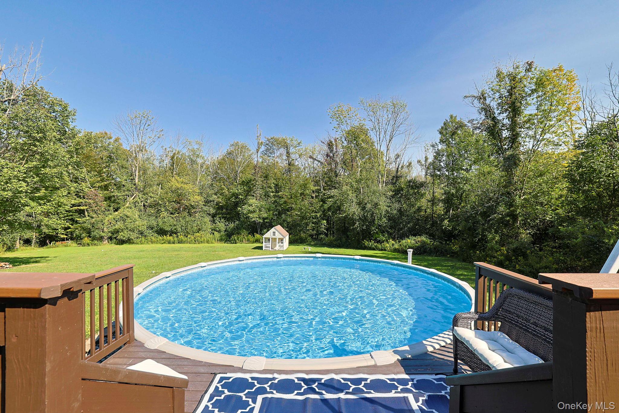 1174 Mountain Road Port Jervis, NY 12771 - Photo 33 of 34 a view of a swimming pool with an outdoor seating and a yard