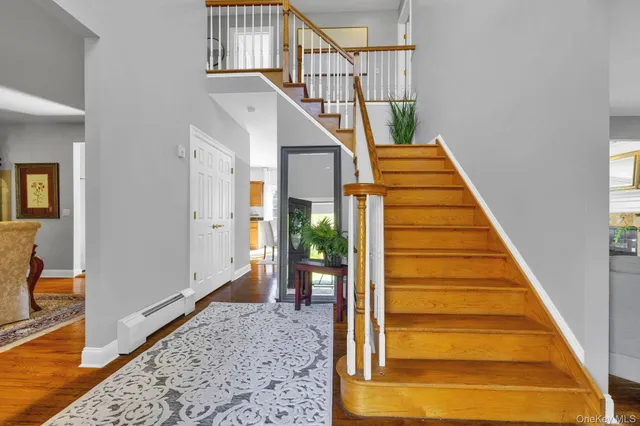 a view of entryway and hall with wooden floor