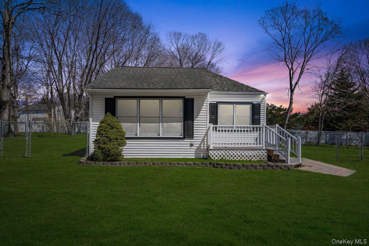 819 Canal Road Mount Sinai, NY 11766 - Photo 1 of 33 The property features a well-maintained lawn and a white exterior with dark shutters
