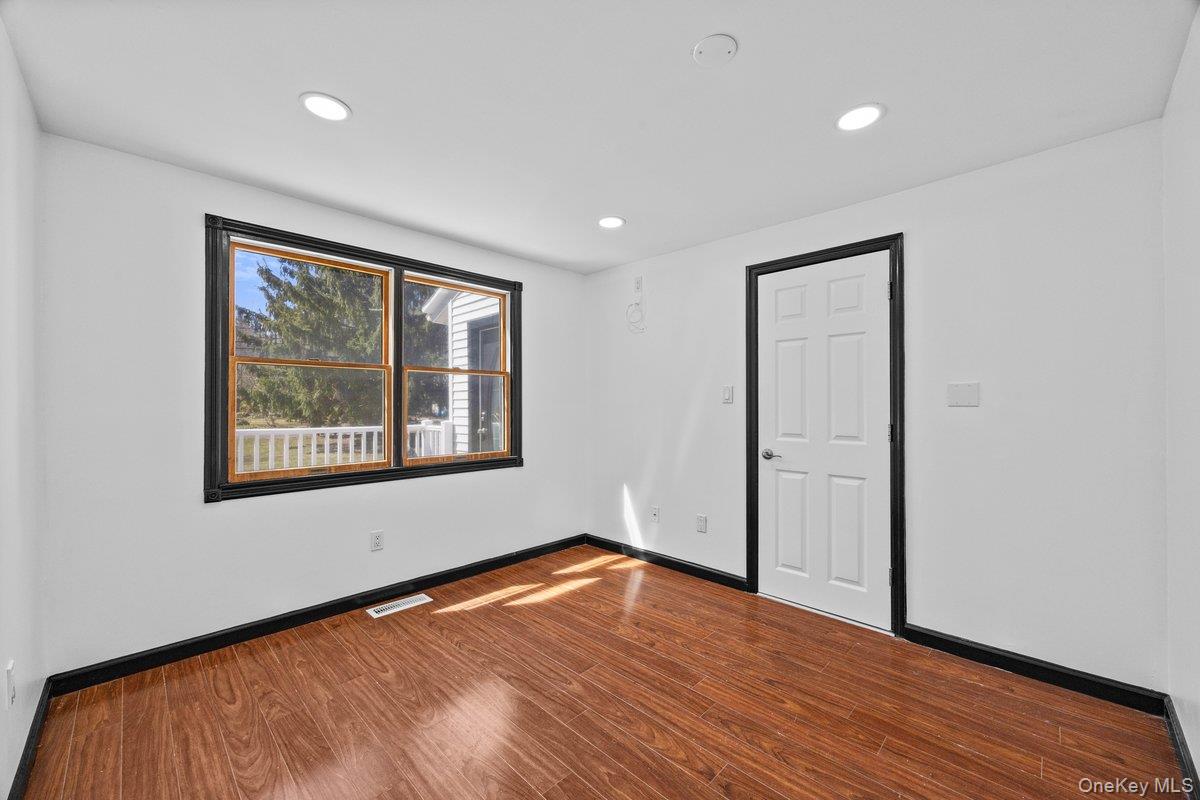 819 Canal Road Mount Sinai, NY 11766 - Photo 11 of 33 Room featuring hardwood flooring, recessed lighting, and a window with exterior views