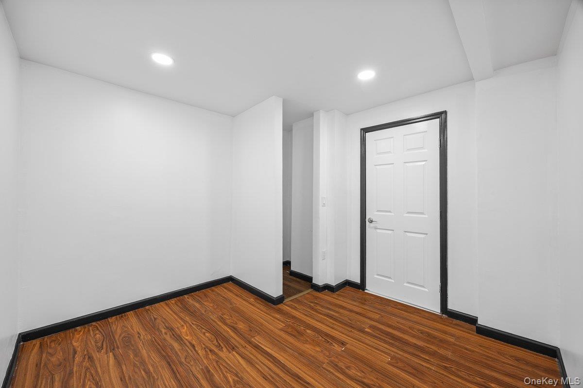 819 Canal Road Mount Sinai, NY 11766 - Photo 13 of 33 This room features wood-look flooring and bright recessed lighting