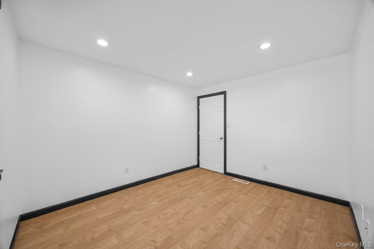 819 Canal Road Mount Sinai, NY 11766 - Photo 15 of 33 This room features light wood flooring, white walls, and recessed lighting