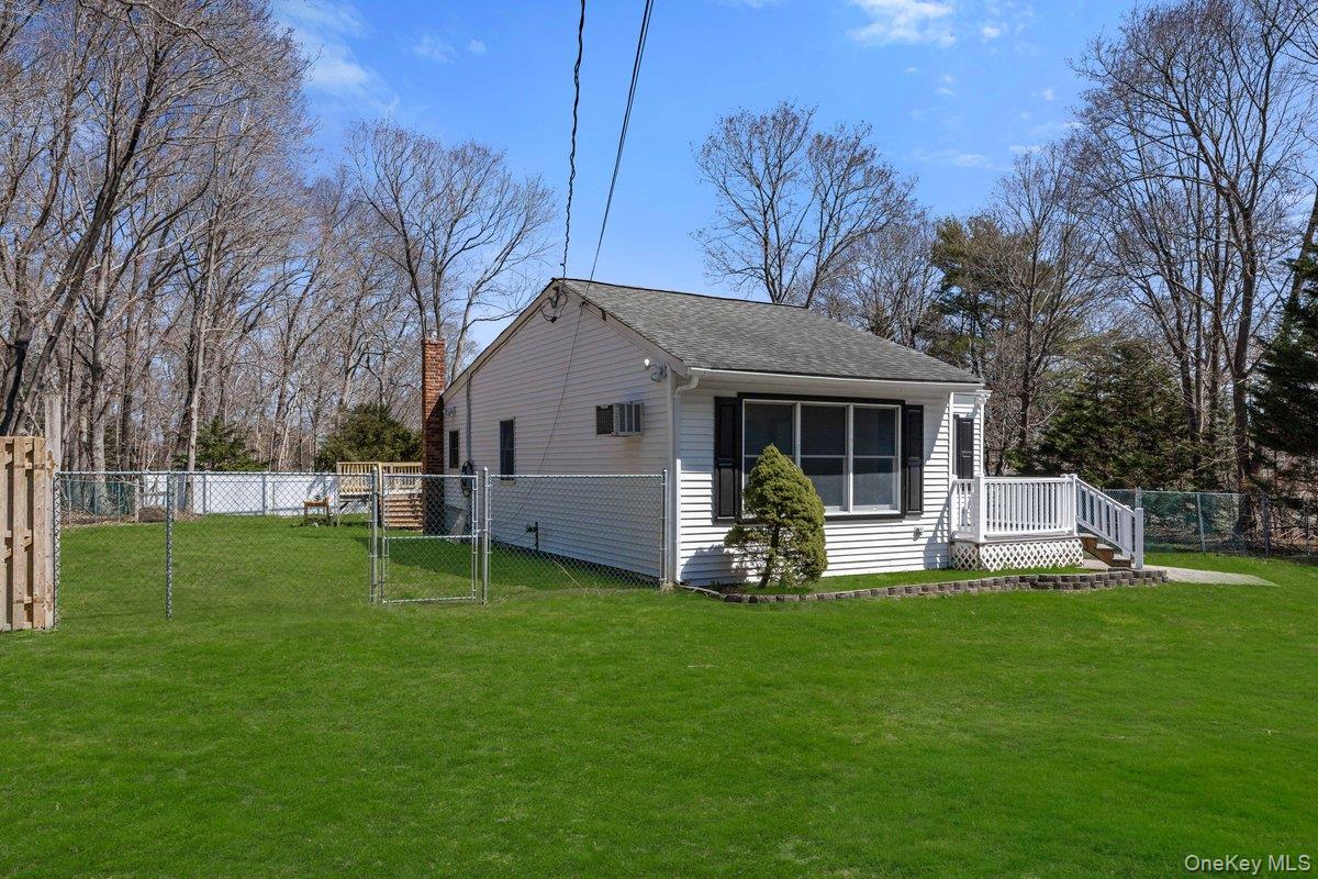 819 Canal Road Mount Sinai, NY 11766 - Photo 4 of 33 The property features a white exterior with black shutters and a front porch