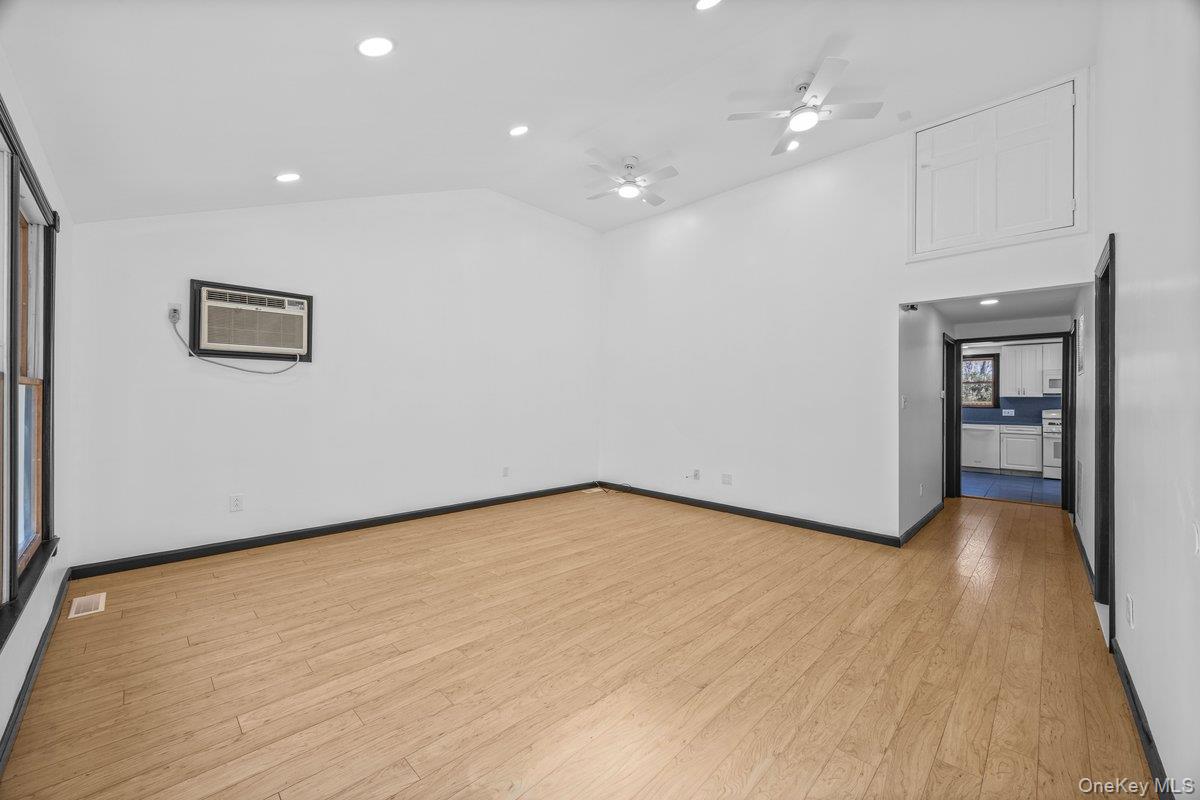 819 Canal Road Mount Sinai, NY 11766 - Photo 6 of 33 Spacious living area featuring light-toned wood flooring, recessed lighting, and a vaulted ceiling