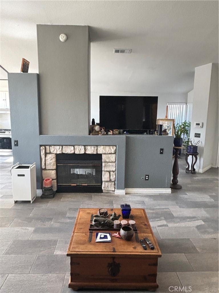 2830-2830 Chuckwagon Road Palmdale, CA 93550 - Photo 4 of 11 a living room with furniture and a flat screen tv