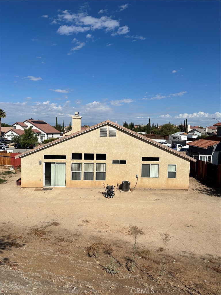 2830-2830 Chuckwagon Road Palmdale, CA 93550 - Photo 5 of 11 a view of a white house with a yard